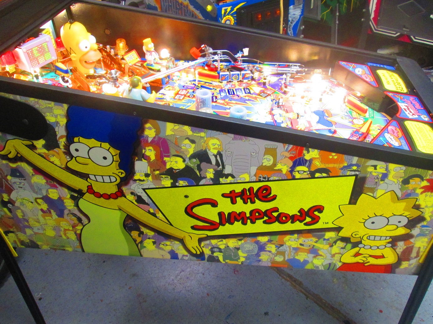 Interesting note on this game: All the voice work was by Dan Castellaneta, Nancy Cartwright, and Hank Azaria, custom recorded for the game. Cabinet and backglass art was created by Simpsons’ guru Matt Groening’s team.